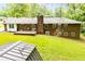 Back exterior view of a home surrounded by mature landscaping at 3047 E Anderson E Dr, Lithia Springs, GA 30122