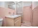 A small pink bathroom features a shower, mirror, and vanity at 3047 E Anderson E Dr, Lithia Springs, GA 30122