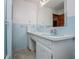Pastel blue bathroom featuring light fixtures and a single sink vanity with storage at 3047 E Anderson E Dr, Lithia Springs, GA 30122