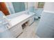 Pastel blue bathroom with light fixtures and a single sink vanity with storage at 3047 E Anderson E Dr, Lithia Springs, GA 30122