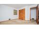 A bedroom with a window, folding closet doors, and a wood door and trim at 3047 E Anderson E Dr, Lithia Springs, GA 30122
