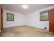 This bedroom has light colored walls and carpet, with wood trim around the windows and a wood door at 3047 E Anderson E Dr, Lithia Springs, GA 30122