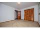 A large bedroom features folding closet doors and a wood door at 3047 E Anderson E Dr, Lithia Springs, GA 30122