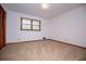 A bedroom with light colored walls and carpet, a window with blinds, and a folding closet at 3047 E Anderson E Dr, Lithia Springs, GA 30122