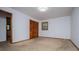 This bedroom has light colored walls and carpet, with a wood trimmed window and a closet with folding doors at 3047 E Anderson E Dr, Lithia Springs, GA 30122