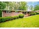Charming brick ranch home with black shutters, a green lawn, and fresh landscaping at 3047 E Anderson E Dr, Lithia Springs, GA 30122