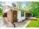 Brick exterior with white trim, concrete patio, chimney, and lush green yard at 3047 E Anderson E Dr, Lithia Springs, GA 30122