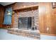 Close-up of a brick fireplace with a wooden mantle and a protective screen at 3047 E Anderson E Dr, Lithia Springs, GA 30122