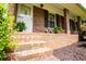 Charming brick front porch with decorative plants and a classic white door at 3047 E Anderson E Dr, Lithia Springs, GA 30122
