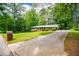 Charming brick ranch-style home with a well-manicured lawn and a long, private driveway surrounded by mature trees at 3047 E Anderson E Dr, Lithia Springs, GA 30122