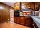 Traditional kitchen with wood cabinets, wood-paneled walls, and a built-in oven at 3047 E Anderson E Dr, Lithia Springs, GA 30122