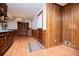 Eat-in kitchen area with wooden cabinets, wood paneled walls, and a closet at 3047 E Anderson E Dr, Lithia Springs, GA 30122