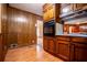 Traditional kitchen with wood cabinets, wood-paneled walls, and a built-in oven at 3047 E Anderson E Dr, Lithia Springs, GA 30122