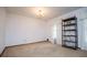 Bright room featuring neutral carpet, large windows, a chandelier, and a decorative bookshelf at 3047 E Anderson E Dr, Lithia Springs, GA 30122