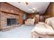 Living room with brick fireplace, wood paneling, carpet and comfortable couches at 3047 E Anderson E Dr, Lithia Springs, GA 30122