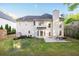 Backyard featuring a patio area with green grass and wooded area at 3145 Maple Terrace Drive, Suwanee, GA 30024