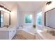 Bright bathroom with a soaking tub, dual sink vanity, and modern fixtures at 3145 Maple Terrace Drive, Suwanee, GA 30024