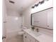 Clean bathroom featuring tile floors, modern vanity with framed mirror, and tub-shower combo at 3145 Maple Terrace Drive, Suwanee, GA 30024