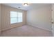 A bright carpeted bedroom with a window and blinds offering natural light and a neutral wall color at 3145 Maple Terrace Drive, Suwanee, GA 30024