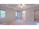Large bedroom with carpeted floor, ceiling fan, and a window for natural light at 3145 Maple Terrace Drive, Suwanee, GA 30024