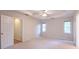 Bright bedroom with a ceiling fan, carpet flooring, and two windows at 3145 Maple Terrace Drive, Suwanee, GA 30024