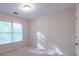 Sunlit bedroom featuring carpet, a window with blinds and neutral wall color at 3145 Maple Terrace Drive, Suwanee, GA 30024