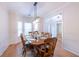Inviting dining area with hardwood floors, large window, and traditional decor at 3145 Maple Terrace Drive, Suwanee, GA 30024