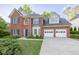 Charming brick home with a well-manicured lawn, two-car garage, and classic architectural details at 3145 Maple Terrace Drive, Suwanee, GA 30024