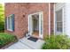 Inviting front entrance with a brick facade, classic door, and well-maintained landscaping at 3145 Maple Terrace Drive, Suwanee, GA 30024
