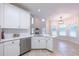 Eat-in kitchen with stainless steel dishwasher and appliances, white cabinetry, and breakfast area at 3145 Maple Terrace Drive, Suwanee, GA 30024