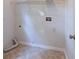The laundry room features neutral paint, tile floor, an overhead rack, and hookups for a washer and dryer at 3145 Maple Terrace Drive, Suwanee, GA 30024