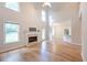 Bright living room with hardwood floors, fireplace, and soaring ceilings filled with natural light at 3145 Maple Terrace Drive, Suwanee, GA 30024