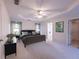 Staged main bedroom with carpet, trey ceiling, ceiling fan, and bright natural light at 3145 Maple Terrace Drive, Suwanee, GA 30024