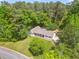 Aerial view of a home surrounded by lush trees and a large yard at 3917 Plantation Dr, Marietta, GA 30062