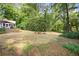 Lush green backyard with plenty of space for outdoor activities and entertaining, surrounded by mature trees at 3917 Plantation Dr, Marietta, GA 30062