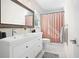 Bright bathroom featuring a double sink vanity and a shower with a curtain at 3917 Plantation Dr, Marietta, GA 30062