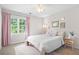 Calm bedroom with natural light, plush bedding, and light pink curtains at 3917 Plantation Dr, Marietta, GA 30062