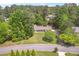 Exterior shot of home with well-manicured lawn, mature trees, and front yard landscaping at 3917 Plantation Dr, Marietta, GA 30062