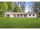 Charming single-story home with white siding, shutters, and a spacious front lawn at 3917 Plantation Dr, Marietta, GA 30062