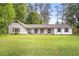 Charming single-story home with white siding, shutters, and a spacious front lawn at 3917 Plantation Dr, Marietta, GA 30062