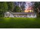 Charming single-story home with white siding, shutters, and a spacious front lawn at 3917 Plantation Dr, Marietta, GA 30062