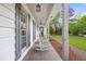 Charming front porch with rocking chairs, brick floor and an American flag waving in the breeze at 3917 Plantation Dr, Marietta, GA 30062