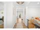 Bright hallway with views into living spaces featuring hardwood floors, neutral paint and modern decor at 3917 Plantation Dr, Marietta, GA 30062