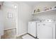 Bright laundry room featuring a modern washer and dryer and ample shelving at 3917 Plantation Dr, Marietta, GA 30062