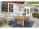 Outdoor patio with seating area, featuring two chairs and a table under a red umbrella, adjacent to the house and screened-in porch at 3917 Plantation Dr, Marietta, GA 30062