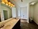 Bright bathroom with a dual sink vanity, soaking tub, and tiled floors at 20 Chapman Way, Covington, GA 30016