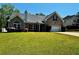 Beautiful brick home with a well-kept lawn, driveway, and lush landscaping at 20 Chapman Way, Covington, GA 30016