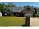 Charming brick home with a well-manicured lawn, driveway, and colorful flowerbeds at 20 Chapman Way, Covington, GA 30016
