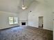 Bright living room featuring high ceilings, a fireplace, and large windows at 20 Chapman Way, Covington, GA 30016