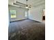 Large bedroom featuring a tray ceiling, carpeted floor, and natural light from 2 windows at 20 Chapman Way, Covington, GA 30016